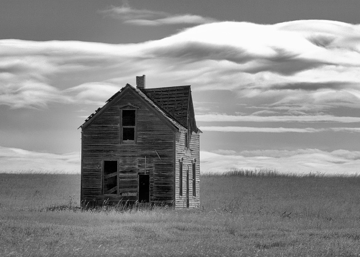 Photograph of an old house in a desolate landscape