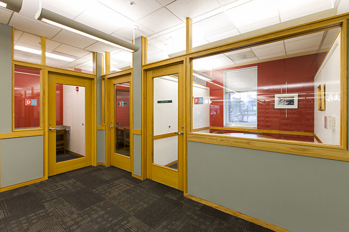 Picture of doors to three study rooms that meet in a corner. The one on the left is a small study room and the other two are larger.