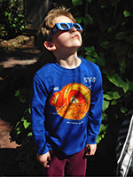 Boy viewing eclipse with eclipse glasses