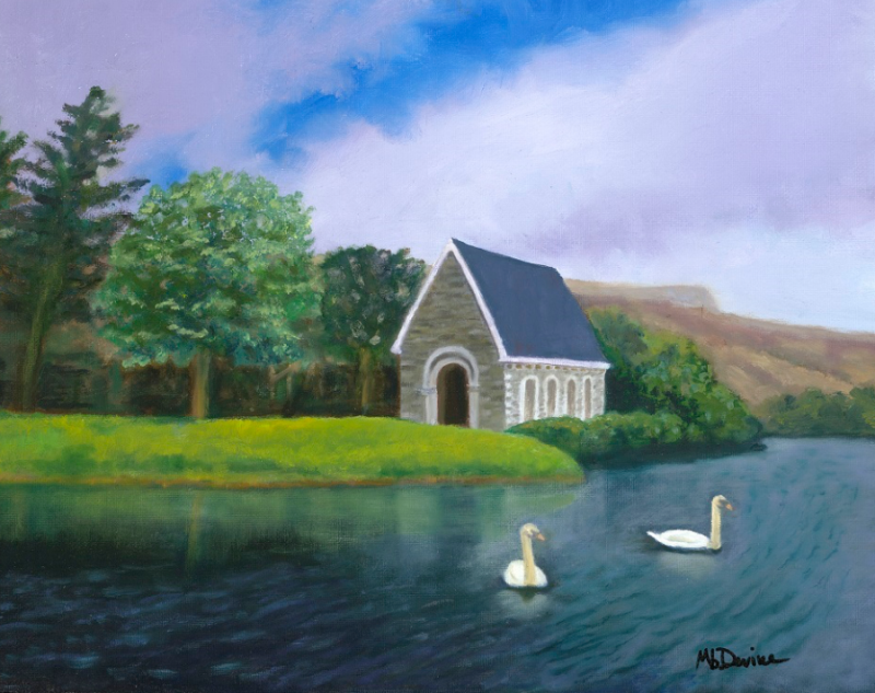 Painting of a lake with two swans with a small gray building on the shore with trees in the background. Painting by GOURGANE BARRA, WEST CORK, IRELAND Marybeth Devine Newmann