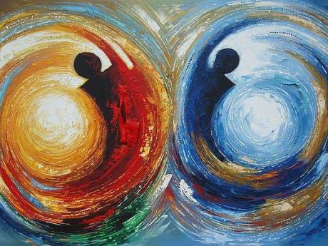 Abstract painting depicting two figures in orange and blue spheres