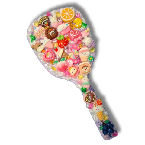 hand mirror with cute colorful charms glued on