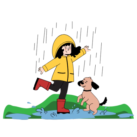 Girl in rain gear splashing in puddle with her brown dog