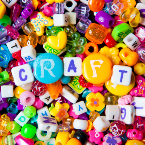 A mix of colorful acrylic beads with beads spelling out "craft" on the top.