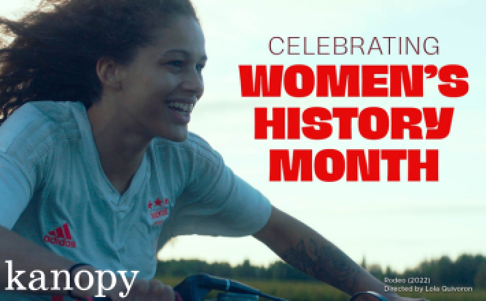 A still from the film Rodeo of a woman riding a bike with her hair blowing in the wind. Text reads "Women's History Month" and the Kanopy logo is in the bottom left.